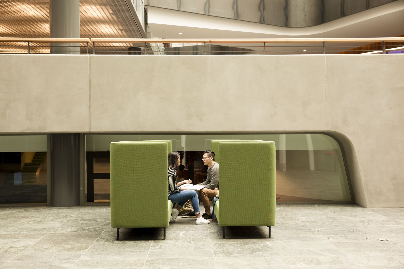 Two people working through something together in a collaborative space